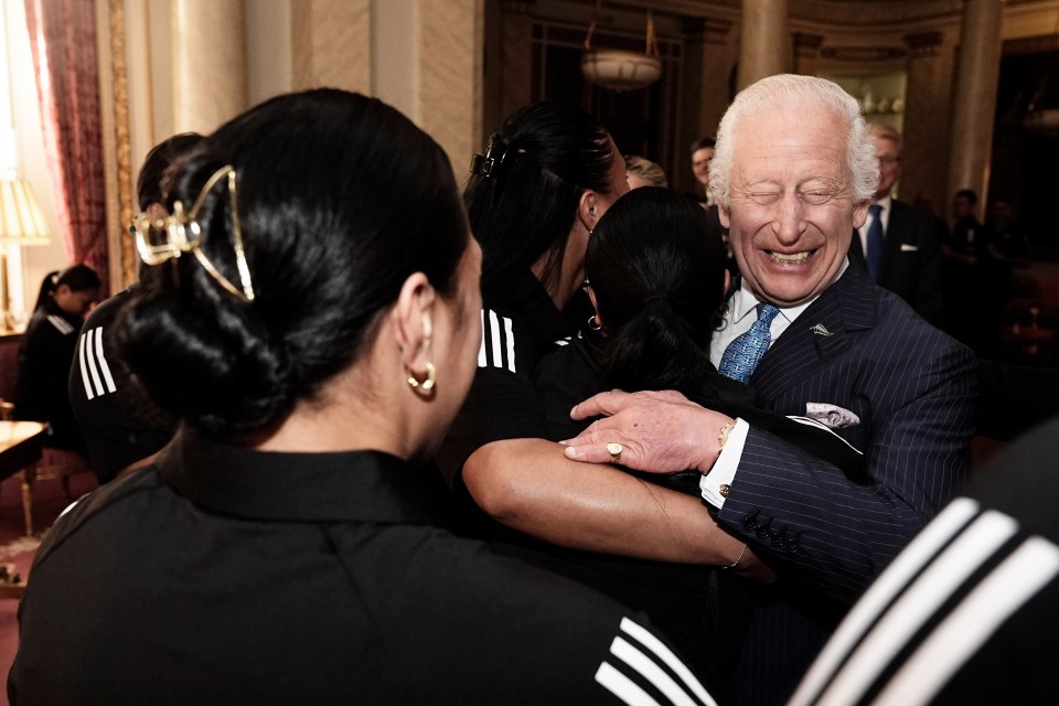 a man in a suit and tie is hugging a woman