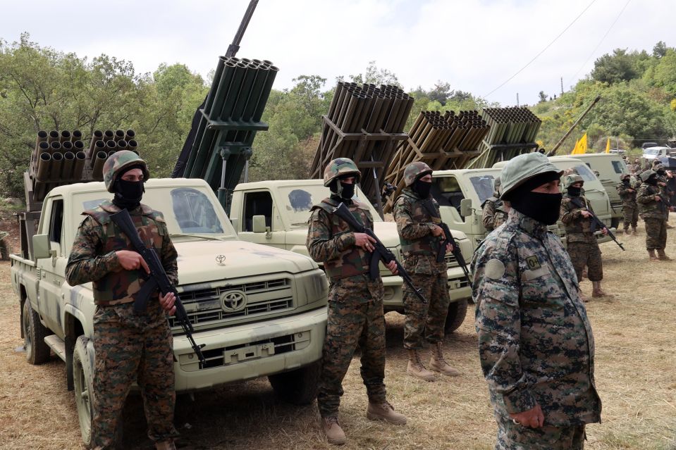 a group of soldiers standing in front of toyota trucks