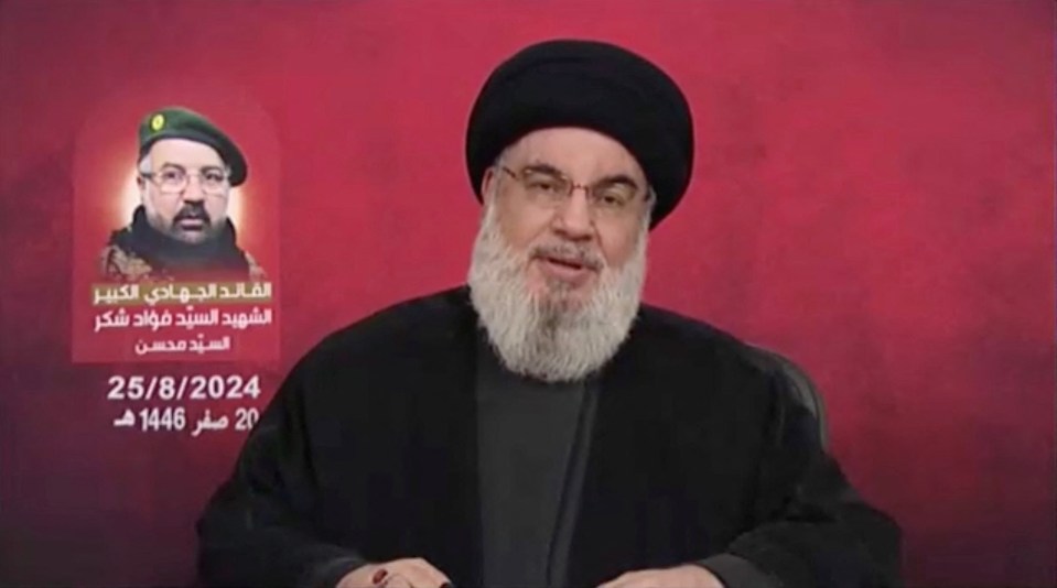 a man with a beard and glasses is wearing a black hat