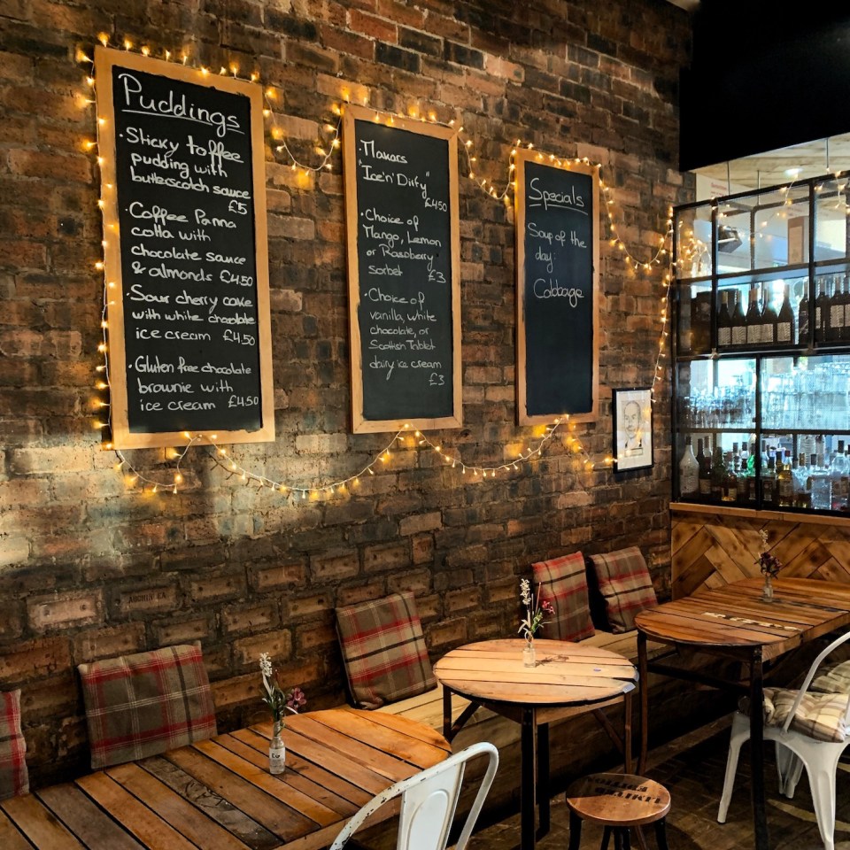 a restaurant with a menu that says puddings on it