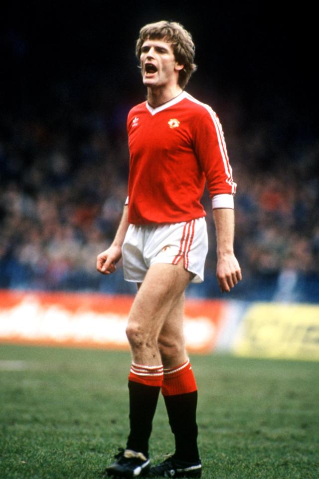a soccer player wearing a red jersey and white shorts