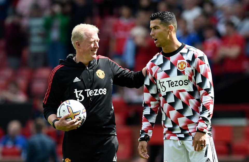 a man holding a soccer ball next to a man wearing a shirt that says tezos