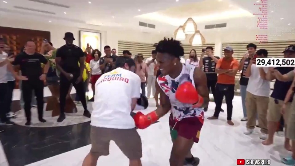 a man in a white shirt that says team pacquiao is boxing