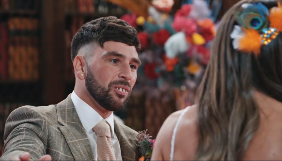 a man in a suit and tie is talking to a woman