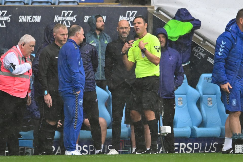 a group of men are standing on a soccer field in front of a shave.com banner