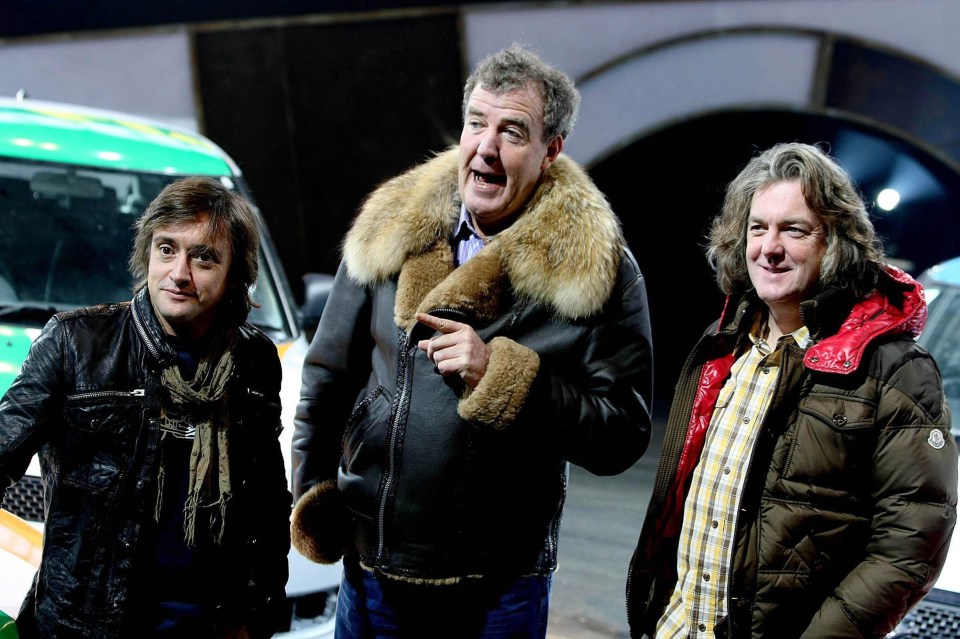 three men standing next to each other with one wearing a fur coat