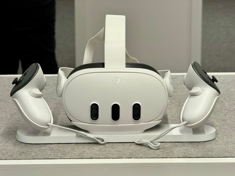 a white oculus rift headset with two controllers attached to it