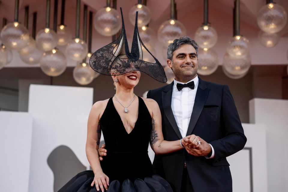 lady gaga and her husband pose for a picture on the red carpet