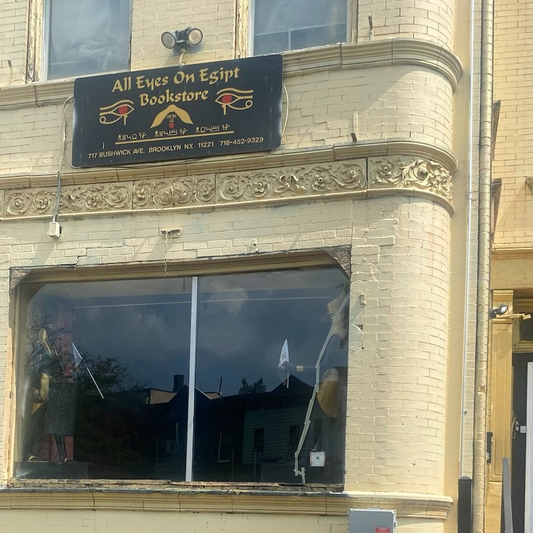 a brick building with a sign that says all eyes on egypt bookstore
