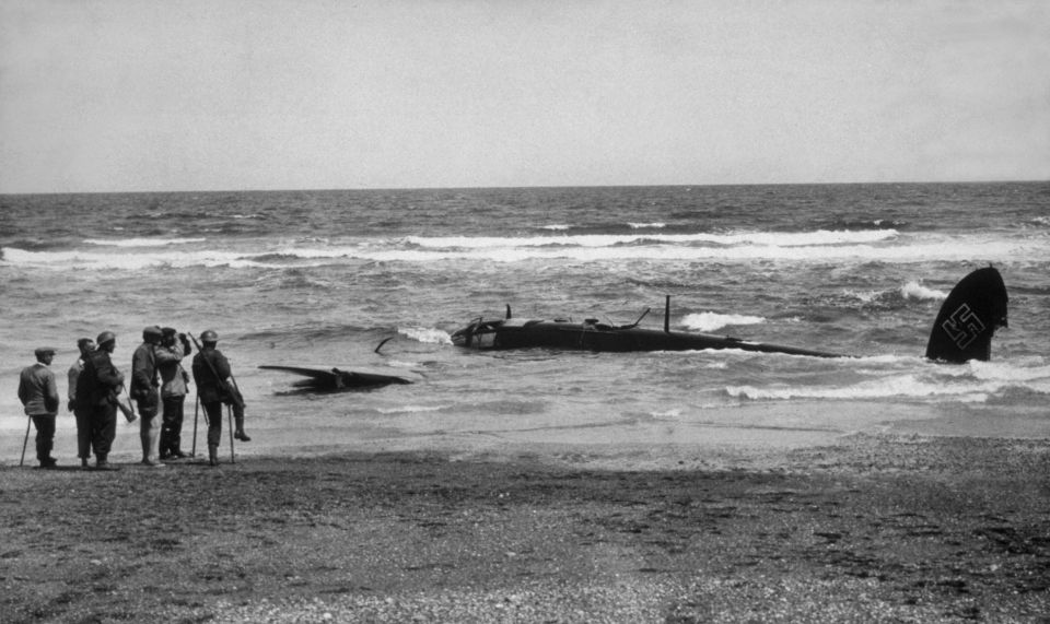 a black and white photo of a plane with the number 55 on the tail