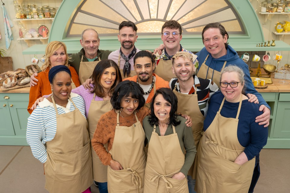 a group of people wearing aprons pose for a picture