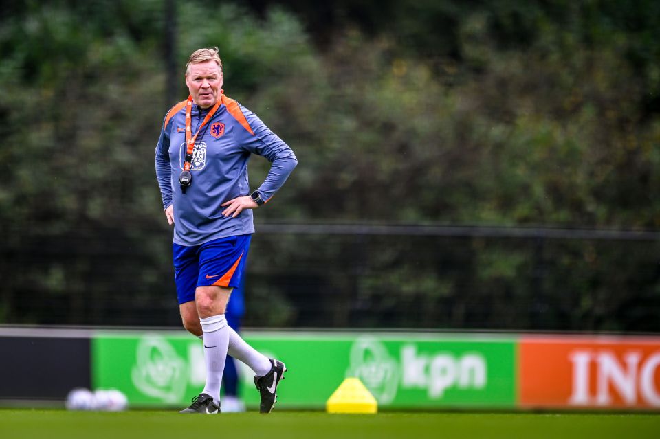 a man walking on a field with a kpn sign in the background