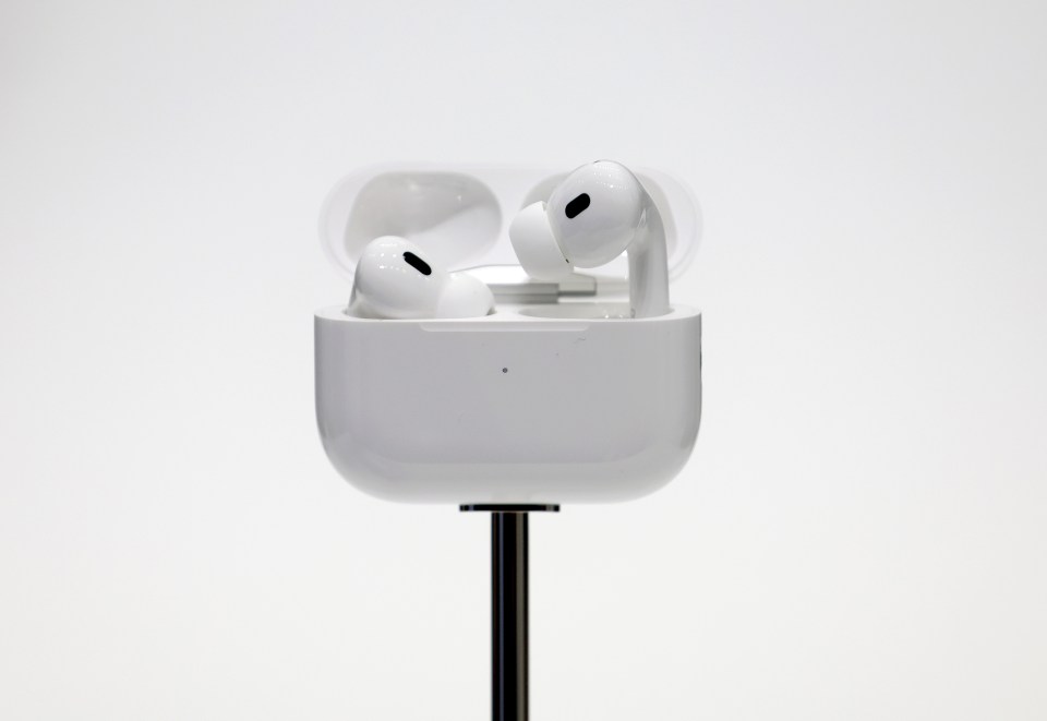 a pair of white earbuds are sitting in their charging case