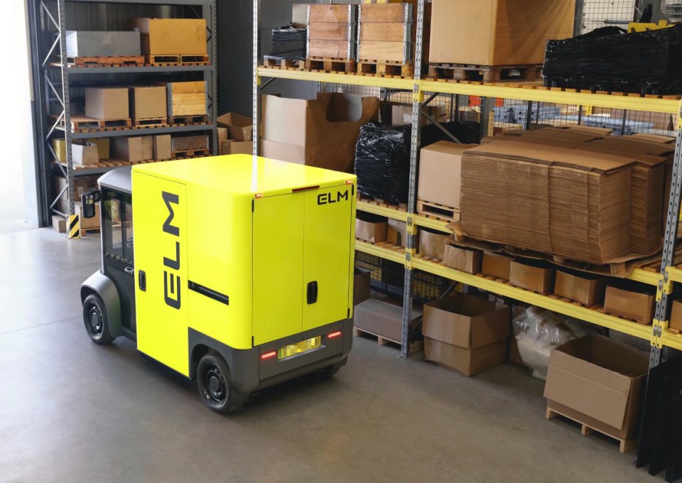 a yellow elm truck is driving through a warehouse