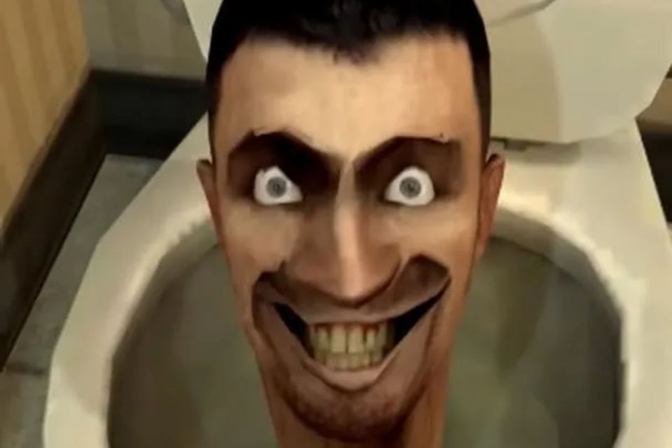 a man with a scary face is sitting in a toilet .