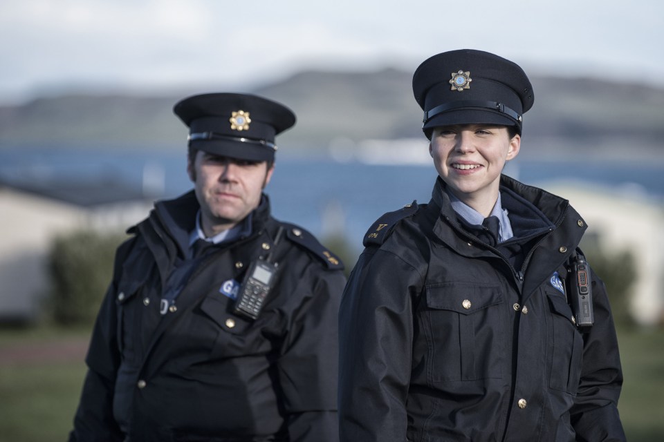 two police officers are standing next to each other and one of them has a badge that says ' g. ' on it