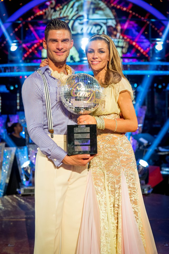 a man and woman holding a trophy that says ' dancing with the stars ' on it