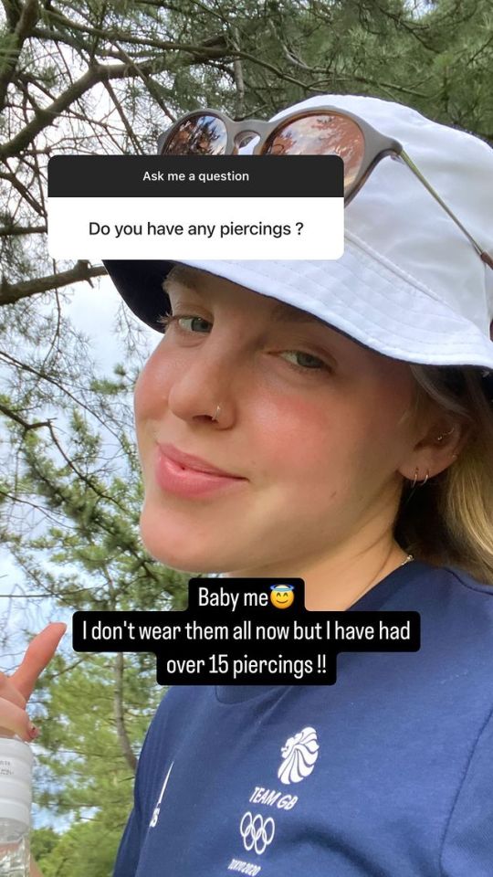 a woman wearing a hat and sunglasses has a question about piercings