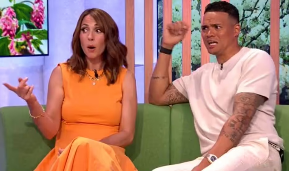 a man and a woman are sitting on a green couch .