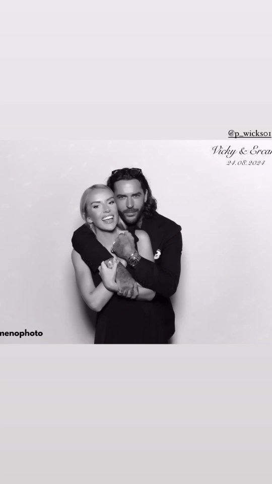 a man and a woman are posing for a photo in a photo booth