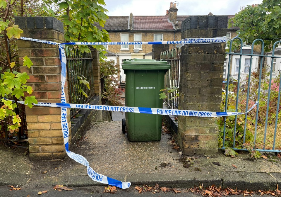 a garbage can is surrounded by police tape that says police line do not cross
