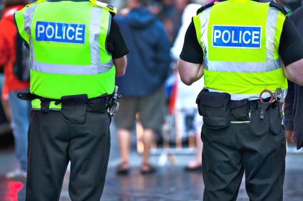 two police officers are standing next to each other