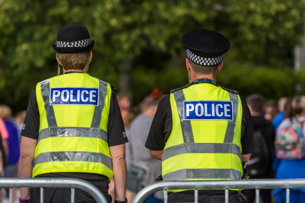 two police officers are standing next to each other