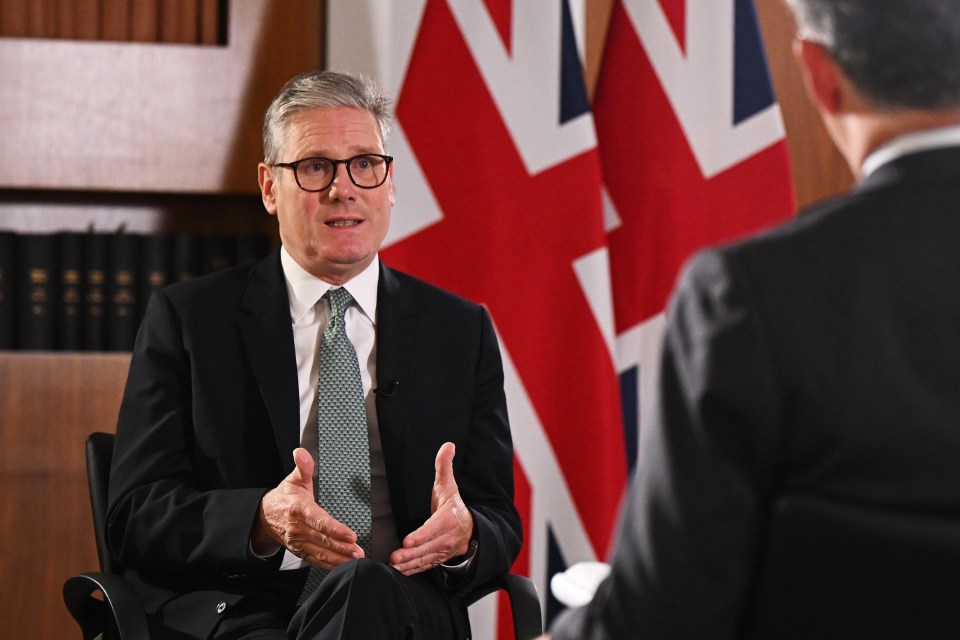 a man in a suit and tie is talking to another man