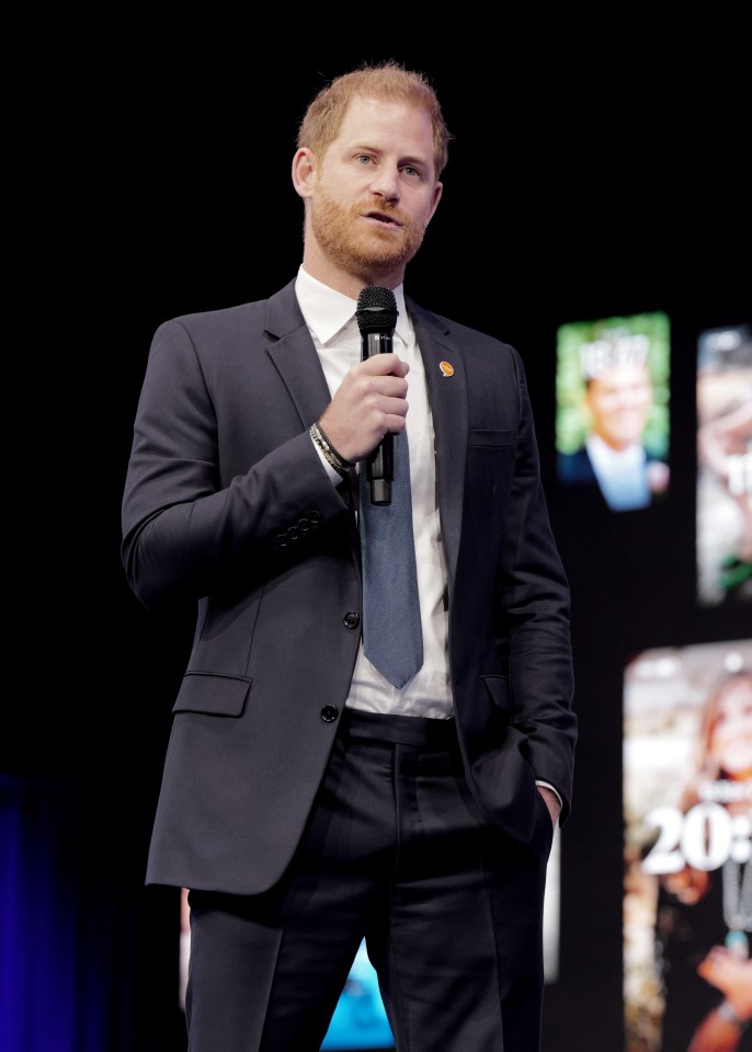 a man in a suit and tie is holding a microphone