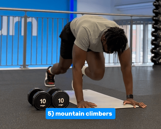 a man is doing mountain climbers in a gym