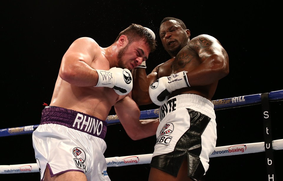 two boxers in a ring with one wearing rhino shorts