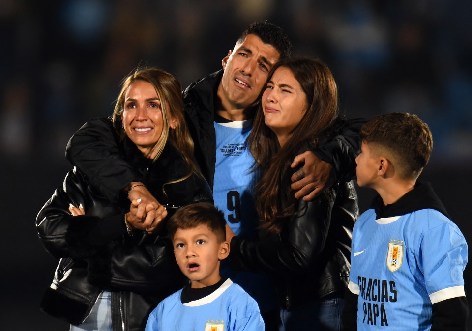 a man wearing a number 9 jersey is surrounded by his family