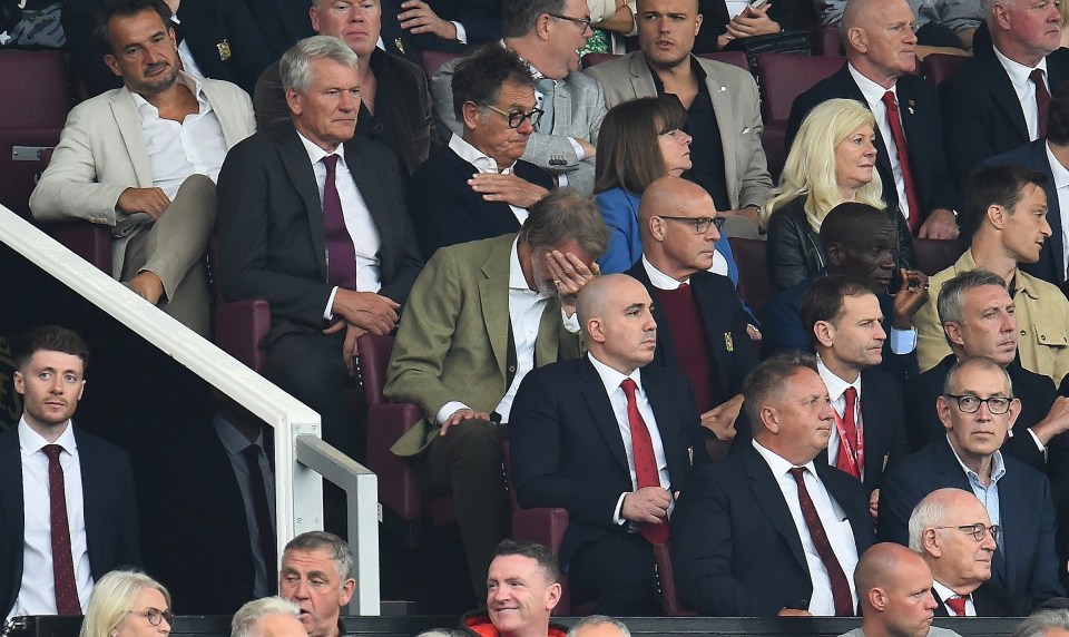 a group of people sitting in a stadium watching a game