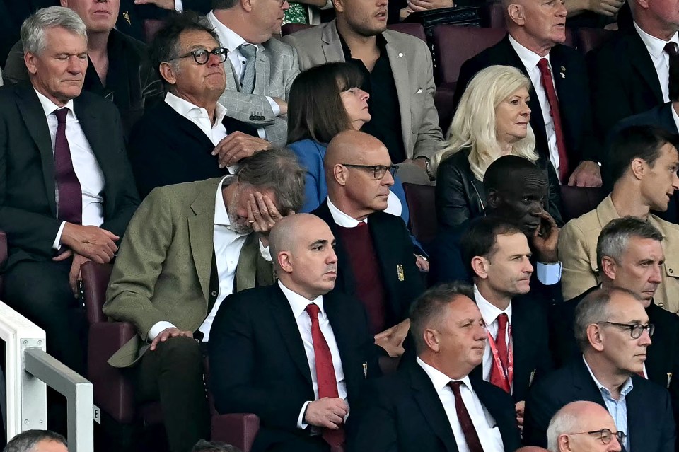 a group of people in suits and ties are sitting in a stadium