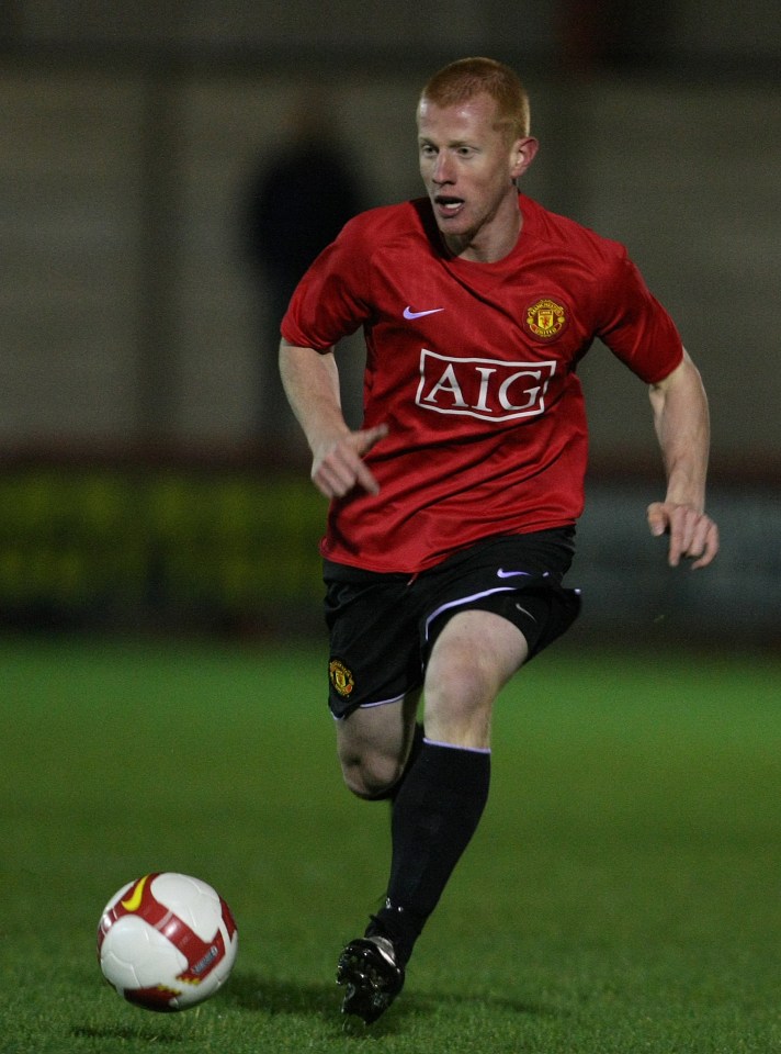 a soccer player in a red aig jersey runs with the ball