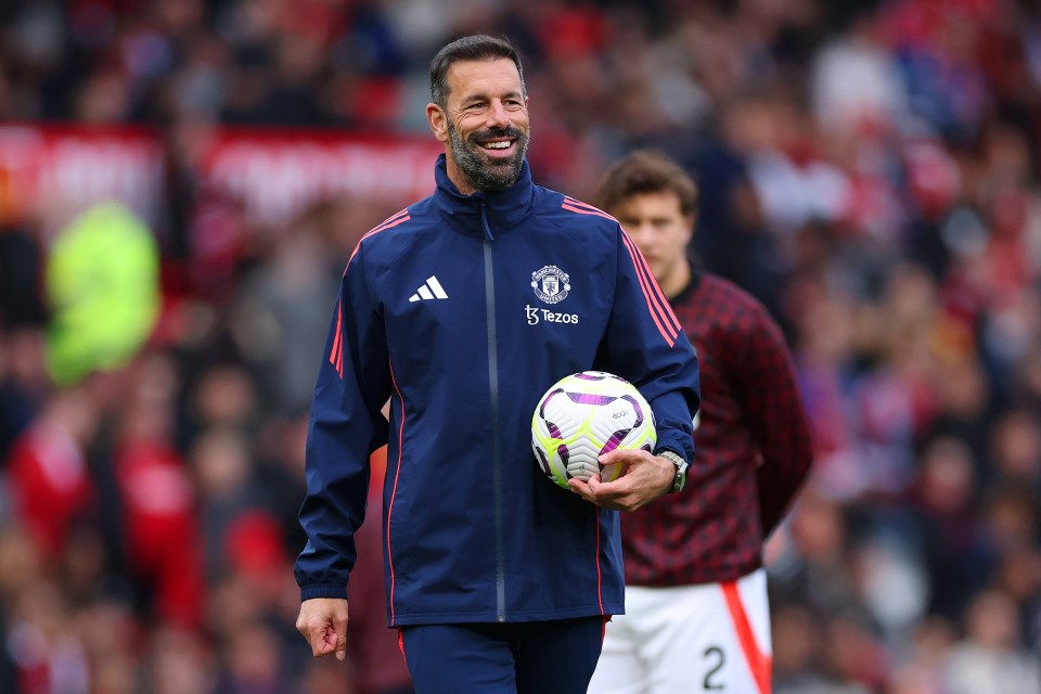 a man wearing an adidas jacket holds a soccer ball