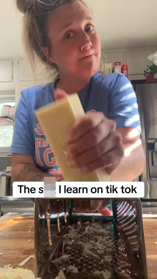 a woman is grating cheese on a grater with the caption " the s i learn on tik tok "