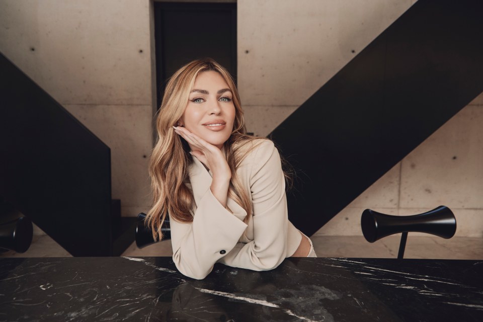 a woman sitting at a table with her hand on her face