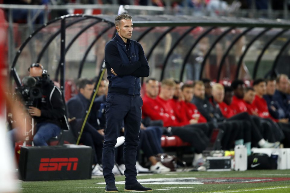 a man stands on a soccer field in front of an espn box