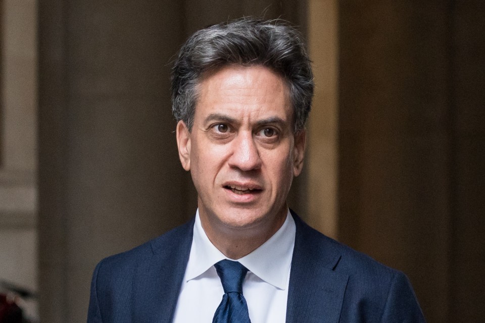a man in a suit and tie looks at the camera
