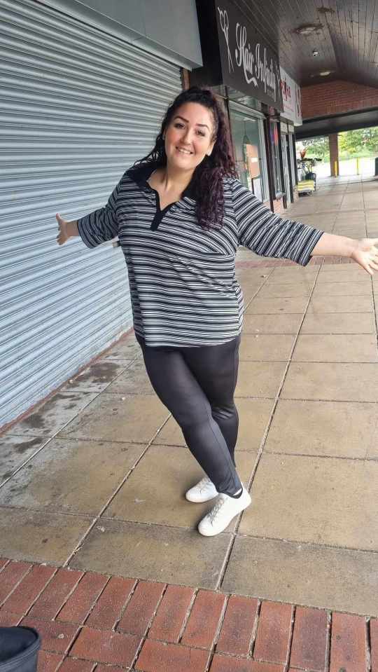 a woman stands in front of a hair infinity store