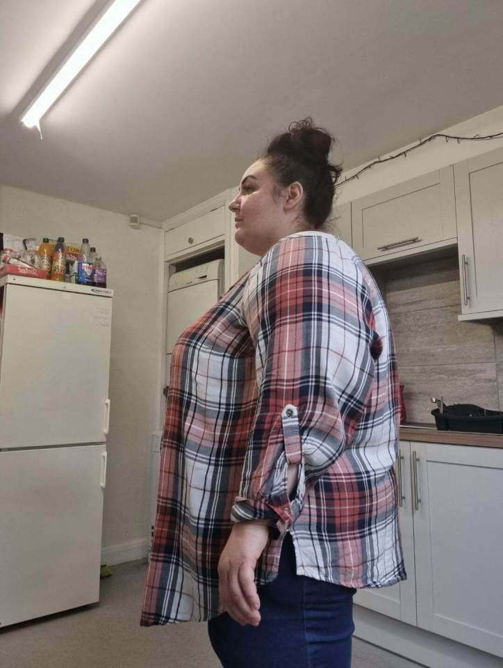 a woman in a plaid shirt is standing in a kitchen