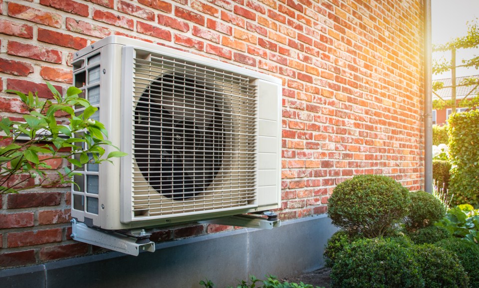a brick wall with an air conditioner mounted on it