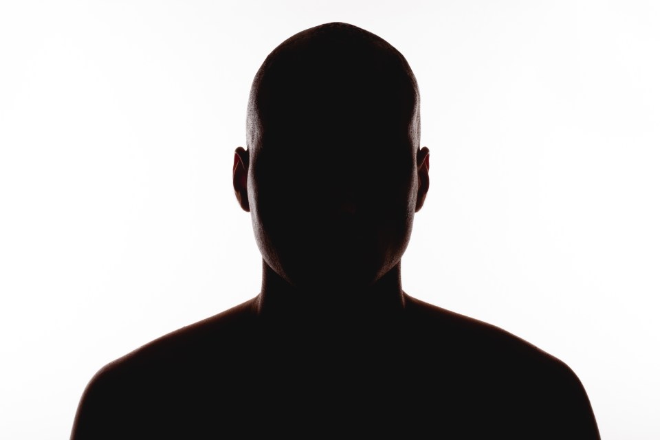 a silhouette of a man 's head against a white background