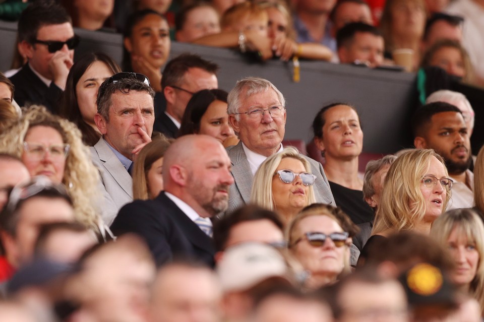 a group of people sitting in a stadium watching a game