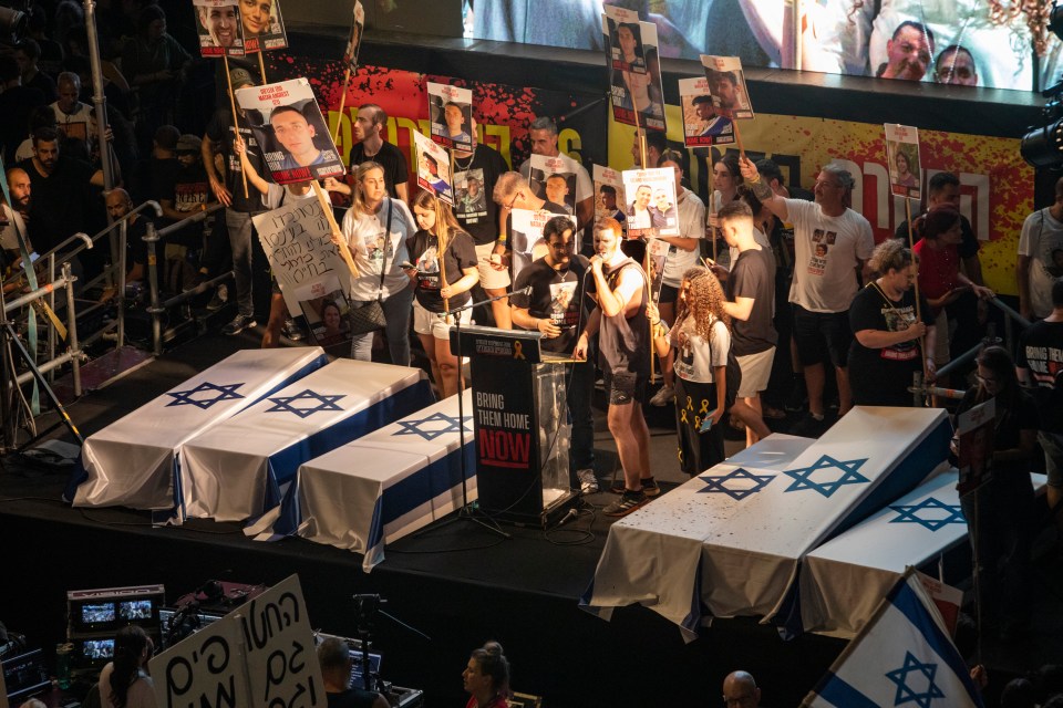 a group of people holding signs including one that says " enough is enough now "