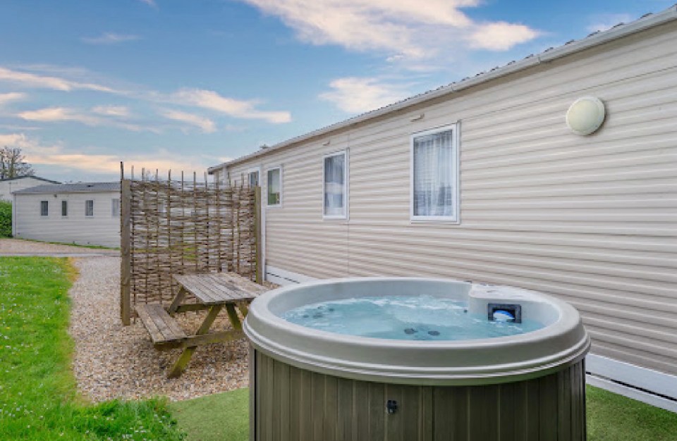 a hot tub sits outside of a mobile home