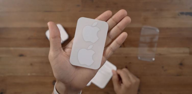 a person is holding an apple sticker in their hand