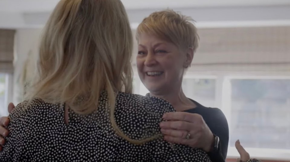 two women are hugging each other and one has a ring on her finger