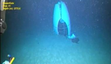 a scuba diver is looking at a blue object in the ocean